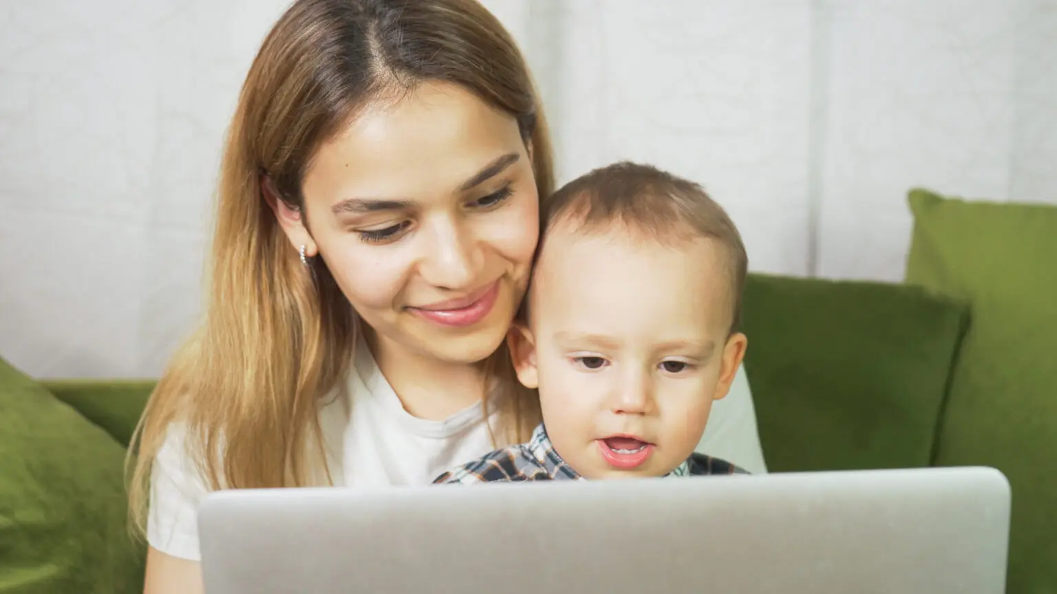 Adoptive mother and young child participating in a video call as part of an open adoption relationship.